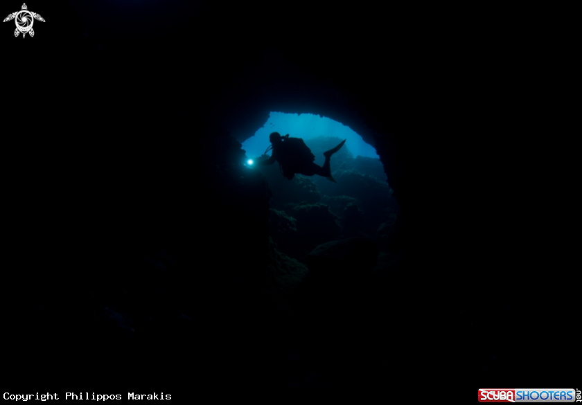 A Diver getting in a cave