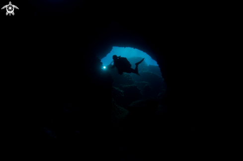 A Diver getting in a cave